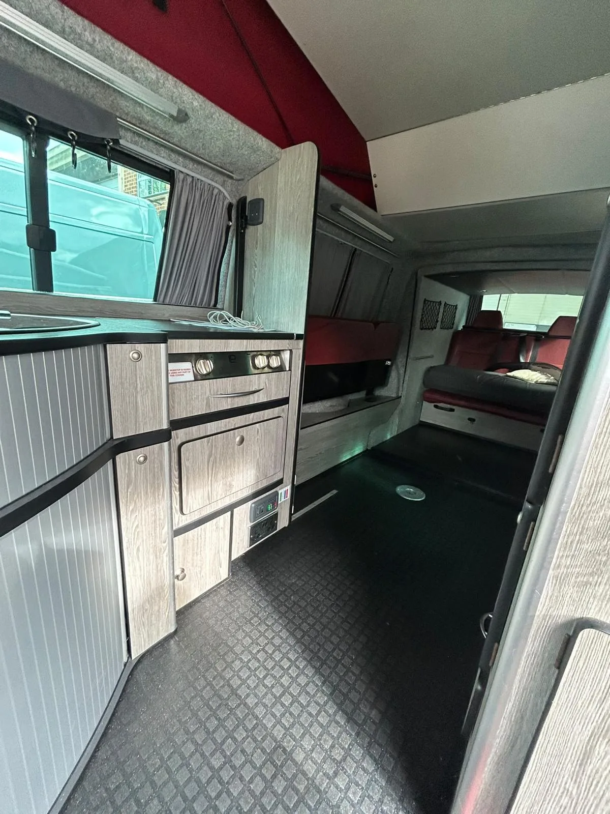 Campervan interior beneath the raised pop-top roof