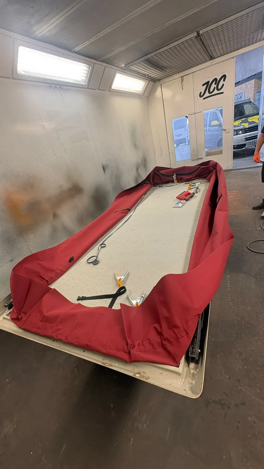 Pop-top roof assembly and fabric being worked on in the workshop